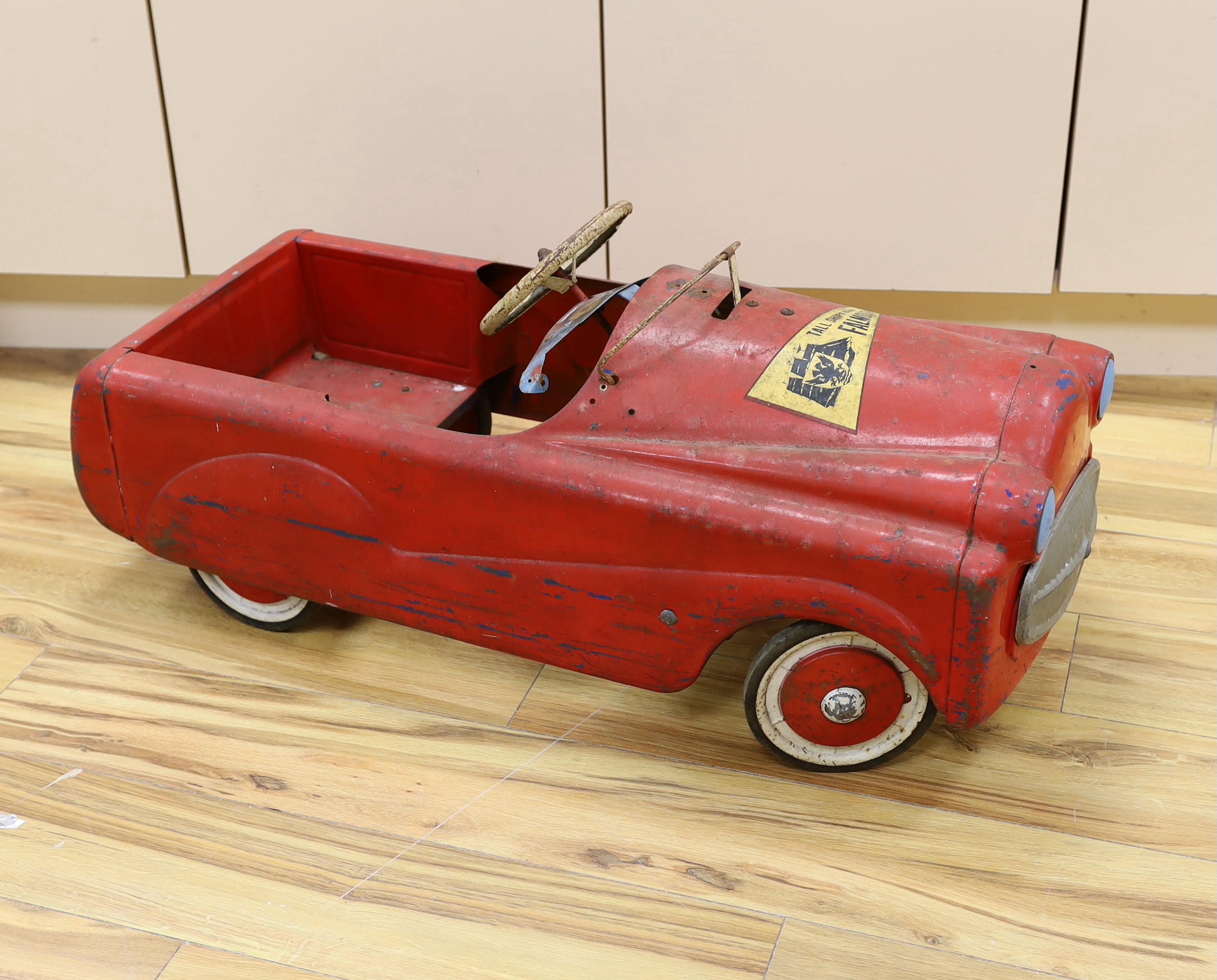 A Sebel tinplate pedal car circa 1960, 90cm long (a.f.)